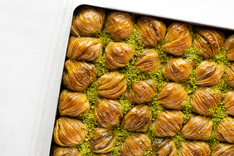 Baklava with green pistachio filling on a white background